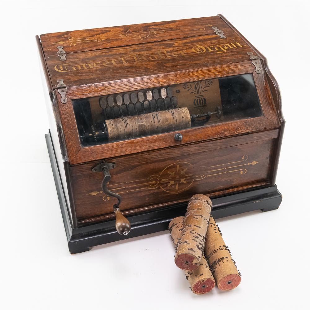 Concert Roller Organ w/4 Cobs: This machine in its oak cabinet has its original finish and stenciling however it has been varnished over some time ago. The mechanism turns and tries to play however is weak and is in need of being r