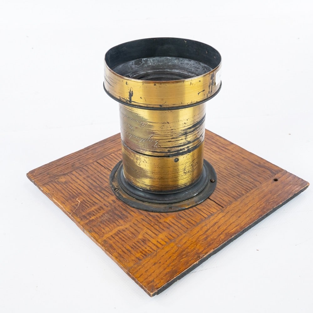 Voigtlander & Son Brass Lens: Vienna and Braunschweig, No. 26172, the element 3 inches, the lens 5 inches long, on oak lens board