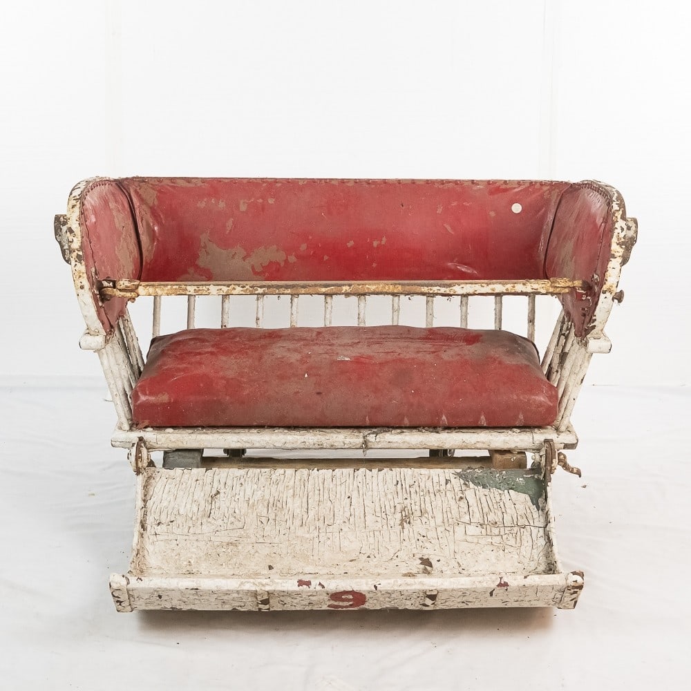 Vintage Ferris Wheel Seat: Wood and metal construction with fold up foot rest and lap bar. In original carnival paint and upholstery. Measures 48" wide, 27" tall, 44" deep with foot rest extended/