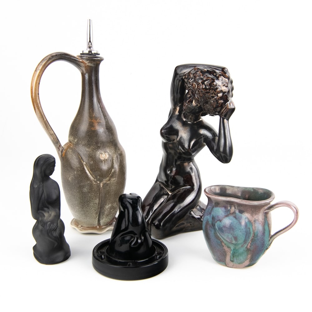 Nude Female Porcelain Pottery Grouping: Very nice collection of various nude female pottery statues. Including "Bottoms Up" shot glass holder, nude female oil bottle with butterfly hallmark, nude female cup, 6" nude female siting statue and
