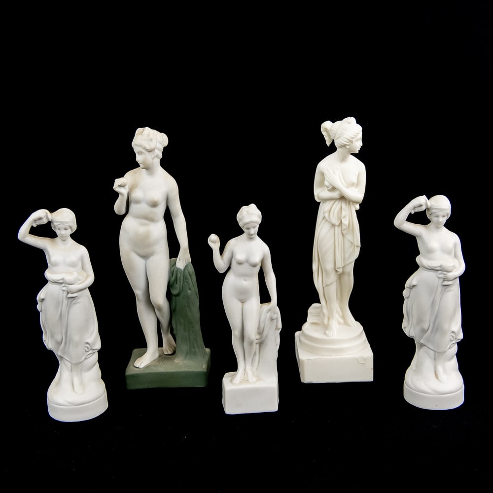 (5) Various Nude Statuettes: Very nice collection of (5) various nude statuettes. 6.5" unmarked bisque porcelain statuette, (3) "Germany" 6882 and 6257 4.75" nude pedestal statuettes and 6.5" unmarked composite nude pedestal stat