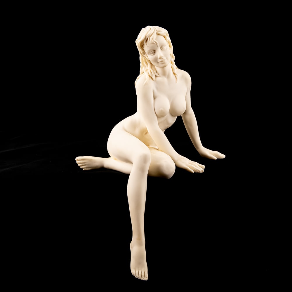 A. Santini Nude Female Oxolyte 9" Statuette: A. Santini nude female oxolyte statuette in very good condition with no chips or cracks noted. Approximately 9" x 9" x 9", original guarantee tag still attached. A. Santini prominently etched along le