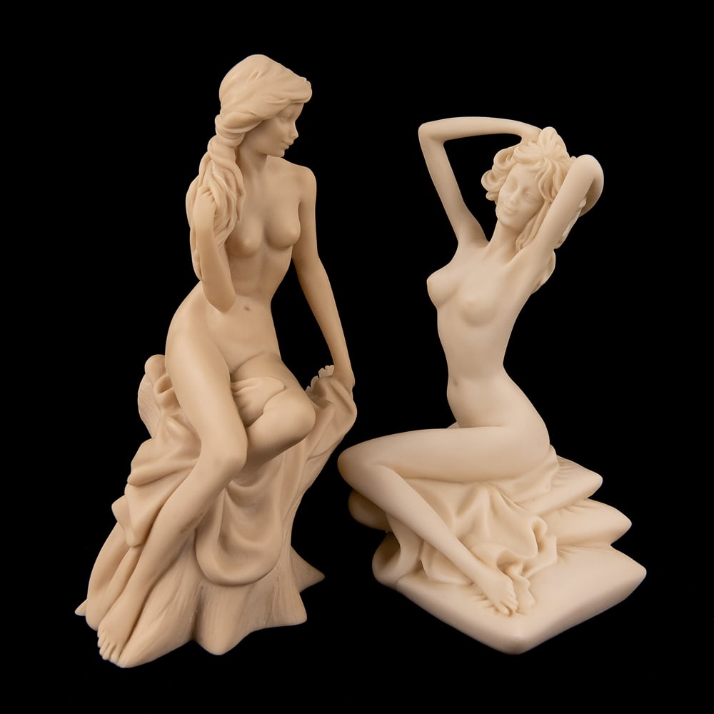 (2) Vittoria Collection Nude Women Statuettes: Collection of (2) Vittoria Collection seated nude woman resign statuettes. Both are in very good condition with no cracks or chips noted, one stands 10" tall while the other example stands 9" tall. Or