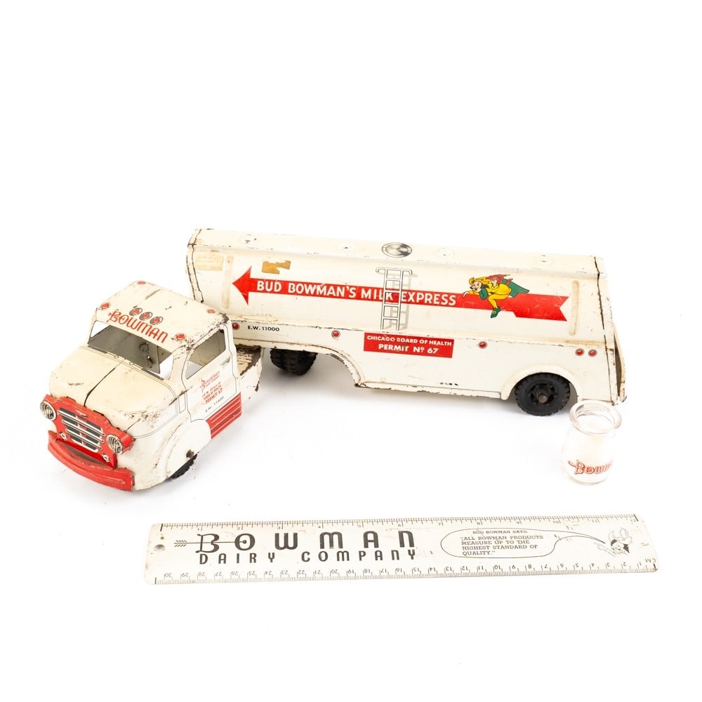 Marx Tin Litho Bud Bowman Dairy Truck & Trailer: Scarce18" Marx Tin Litho Bud Bowman Dairy Toy Truck and Trailer with Bowman ruler and mini glass jug. Truck is in good overall condition with scuffs and wear present indicative of age and use. Perfect