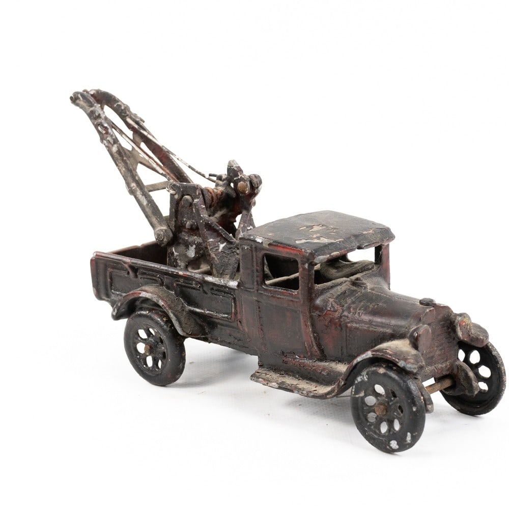 Antique Arcade Cast Iron Ford Model A Tow Truck: Hard to come by antique Arcade cast iron Ford Model A toy tow truck #210. Good overall condition with wear marks present indicative of age and use. Approximately 10" L x 3"w x 5"t. Perfect addition to