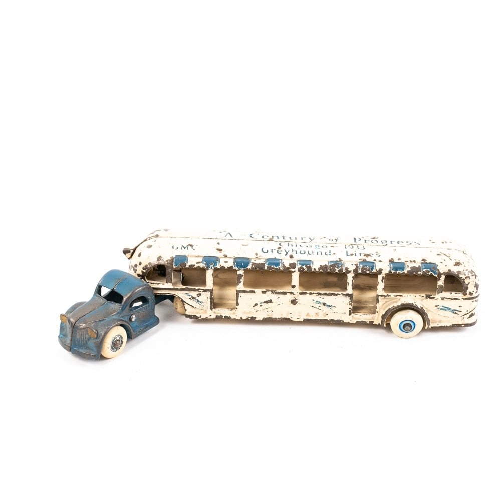 Arcade 1933 Century of Progress Greyhound Bus: 1933 Arcade A Century of Progress GMC Greyhound Lines toy 11.5" cast iron bus. In good to fair overall condition with wear and scuffs present; indicative of age and use. One of the trailers wheels com