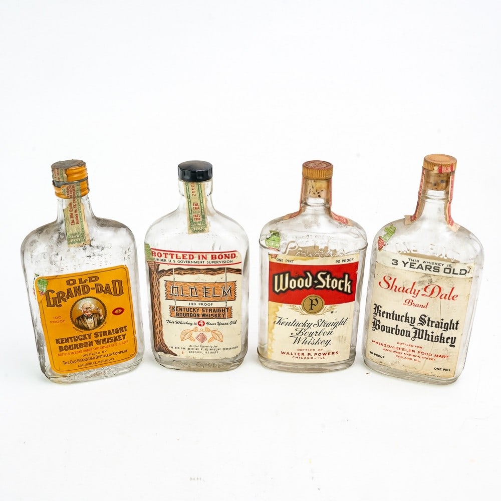 Four Vintage Whiskey Bottles With Labels: Four one pint whiskey bottles circa 1930's. Shady Dale, Old Grand-Dad, Old Elm and Wood-Stock. All four are in good original condition with front and back labels and federal tax stamp. Please review a