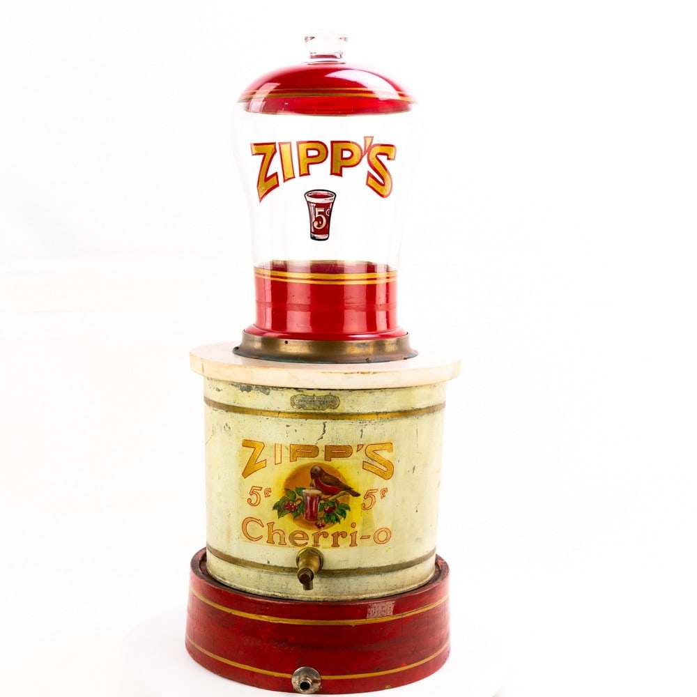 Zipp's Cherri-O Soda Fountain Dispenser: Multi-peice dispenser with original paint and artwork on lower ice container and center syrup dispenser. The upper marble and glass looks old with contemporary lettering and artwork. Has brass nozzle 