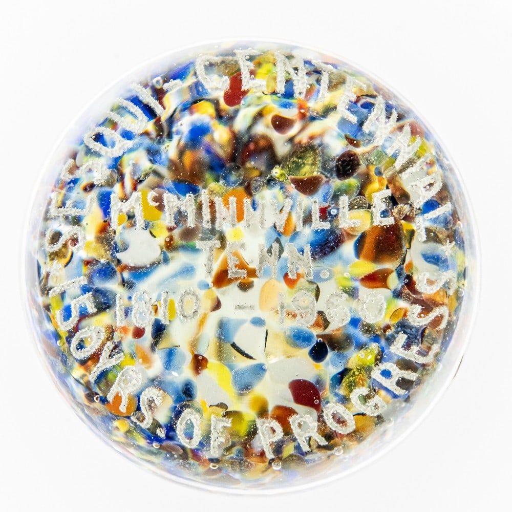 Glass Sesquicentennial Souvenir Paper Weight: Glass McMinnville Tennessee Paperweight, in great condition with no noticeable scratches or defects. Has Multi-Colored bottom with white "150 Yrs. Of Progress" text. Measures approx. 3"H X 3.25"W X 3.