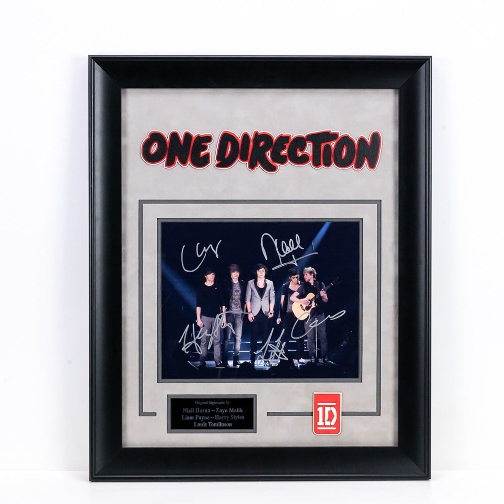 One Direction "1D" English-Irish Pop Boy Band: Signatures of Niall Horan, Zayn Malik, Liam Payne, Harry Styles and Louis Tomlinson with COA. 16 3/4" X 20 3/4" Note: Donley Auctions does not warranty any third party COA's or authenticity.