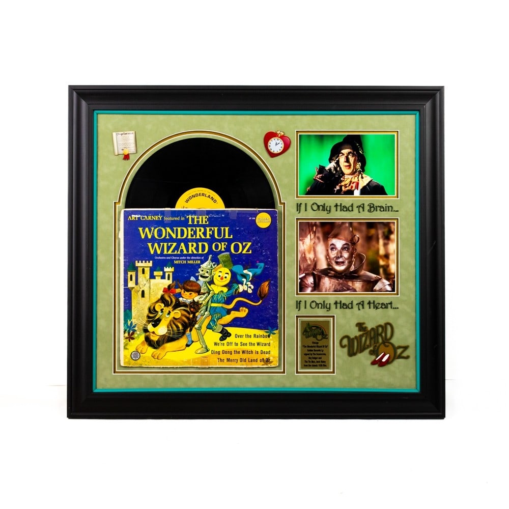 "The Wonderful Wizard of OZ" LP Record Signed: Photographs from the 1939 film with signatures of The Scarecrow, Ray Bolger, and The Tin Man, Jack Haley. COA issued by Guaranteed Forensic Authenticators LLC. Some light scratch marks to the front pl