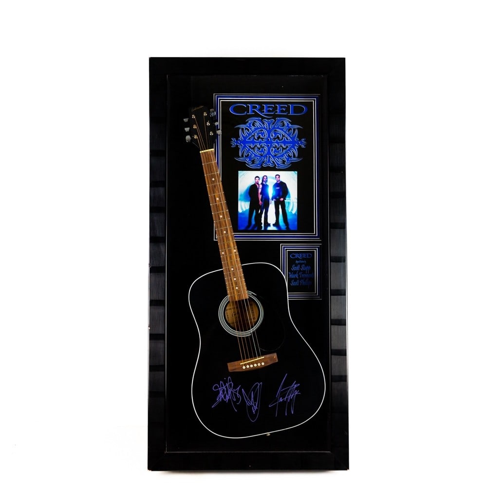Creed - Grammy Award Winners Signed Guitar: Signatures of Scott Stapp, Mark Tremonti and Scott Phillips with a COA issued by Authentic Autographs Unlimited. Condition: very good. Dimensions: 48 1/4"h X 23 1/8"w X 5 1/2"d. Please review all phot