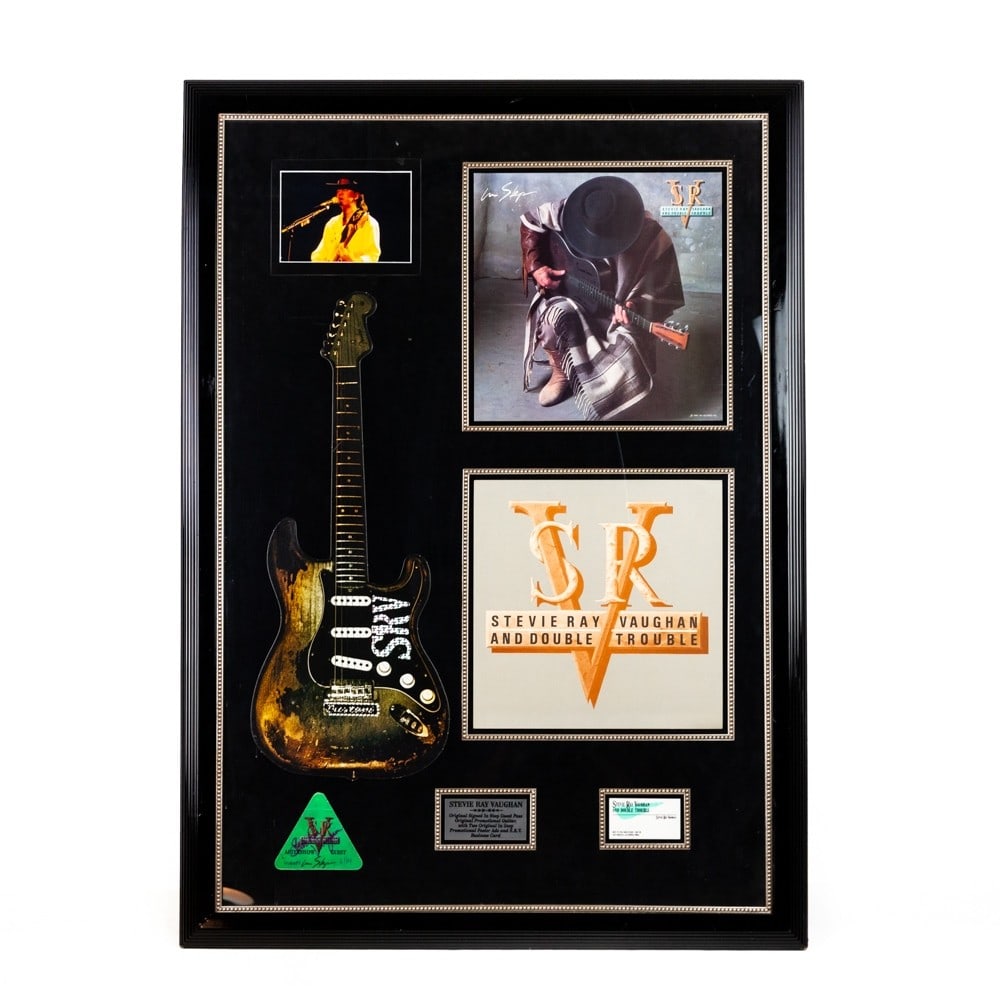 Stevie Ray Vaughn Guest Pass Signed: Signed "In Step" guest pass, original promotional guitar, two In Step promotional poster advertisements and a COA issued by Authentic Autographs Unlimited.. 31 1/8" X 43 1/8" There are several scratch