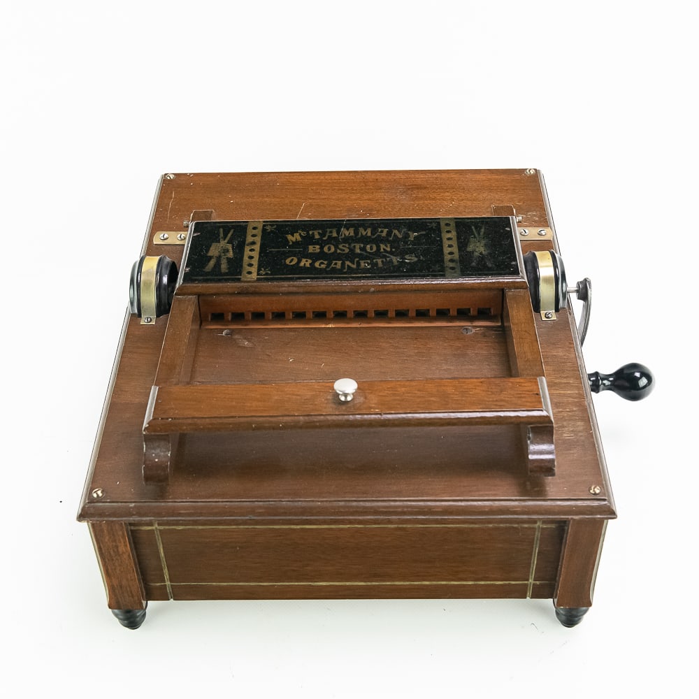 McTammany Hand Crank Organette: 14 note hand crank wood organette uses 9.375" wide book music (none included). Wood Good bellows, notes sound loud when cranked. Measures 13.5" long, 11.75" wide, 7" tall