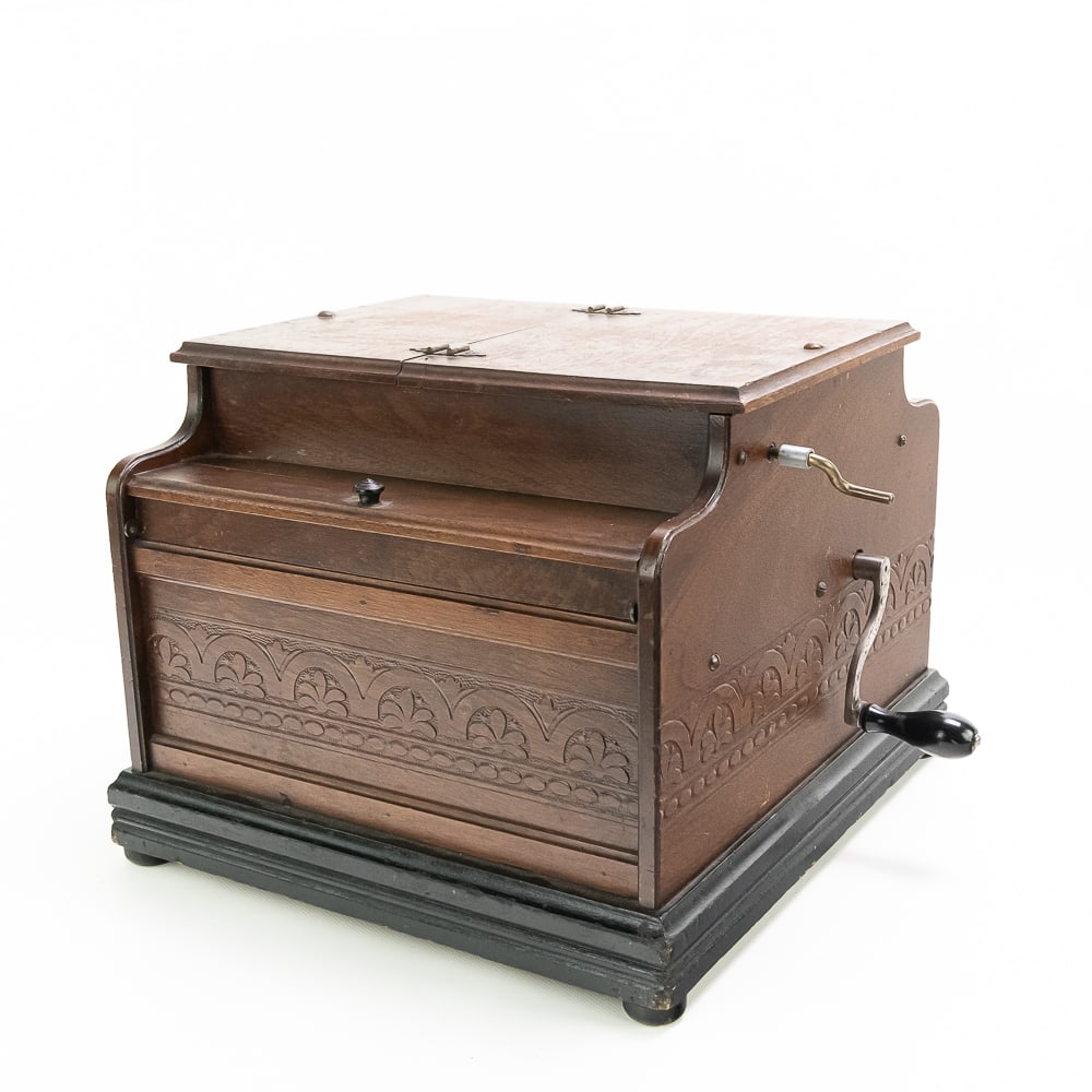 Mascotte Roller Organ: Mascotte roller organ by Gately Manufacturing Co., plays perforated 2 3/4" rolls with one patriotic Civil War roll included. Pressed & stencilled walnut case with original finish, some minor losses to