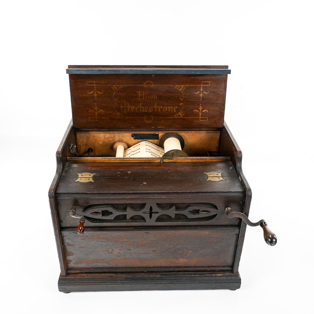 Bijou Orchestrone Paper Roll Organ: This machine in its wood cabinet has its original dark brown finish and stenciling which is dark and dirty with some finish loss mainly on the left and front sides. See photos. Cabinet also features 2