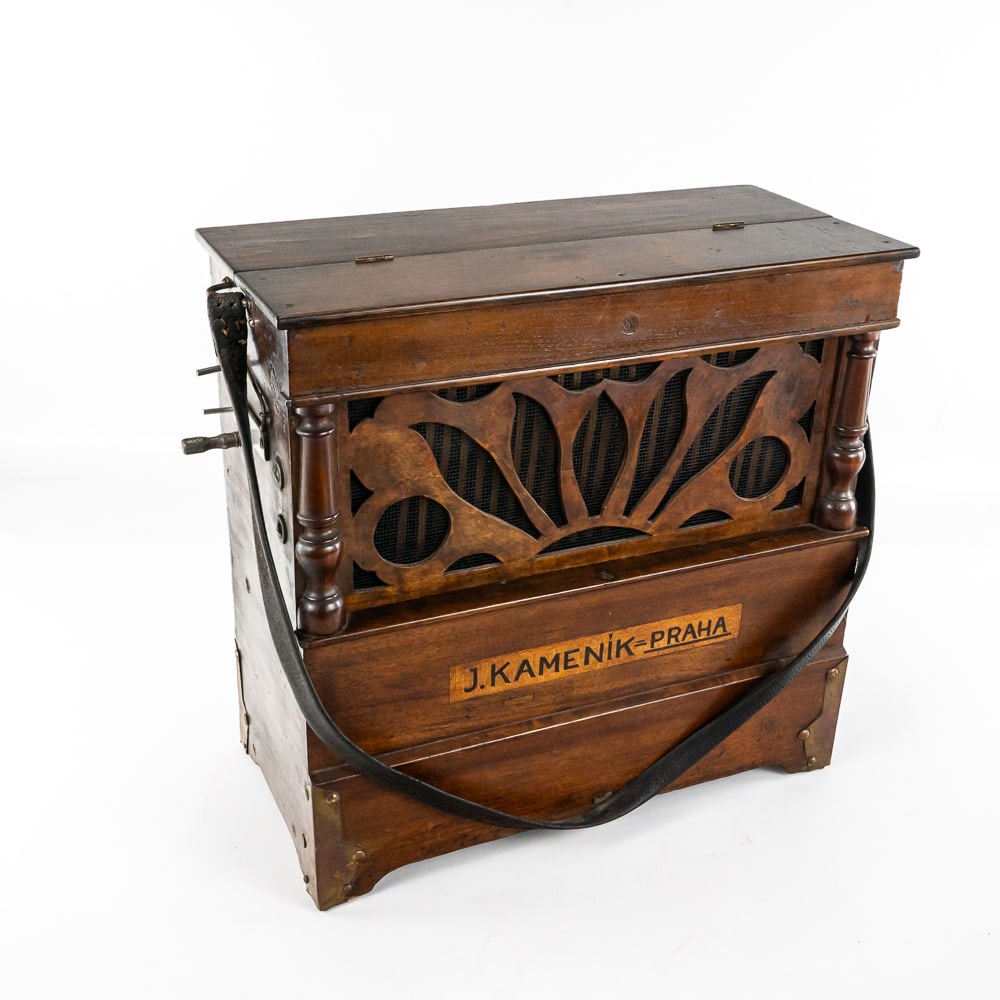 J. Kamenik Czech Barrel Type Organ: This barrel organ in its wooden cabinet which is made of various woods has its original finish with the usual nicks and scrapes from many years of use. The cabinet features a decorative wooden front g