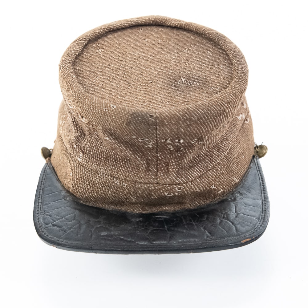 Civil War Confederate Kepi-Richmond Butternut: This is a very nice example of a mid-war Richmond Va. production Confederate kepi. The body is a very muted butternut brown colored denim twill material. The chinstrap button are chicken neck Union ea