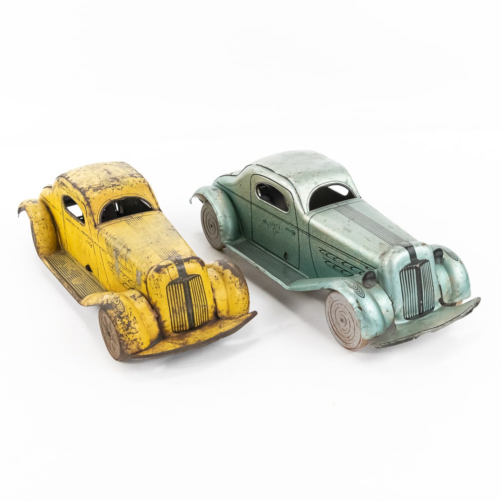 Pair of 1930s MARX Pressed Steel Mystery Cars: Pair of 1930s MARX pressed steel Mystery Car toy friction cars. Good to fair overall condition with age & wear marks including dings, discoloration, surface rust, scuffs & scratches. Friction on both 