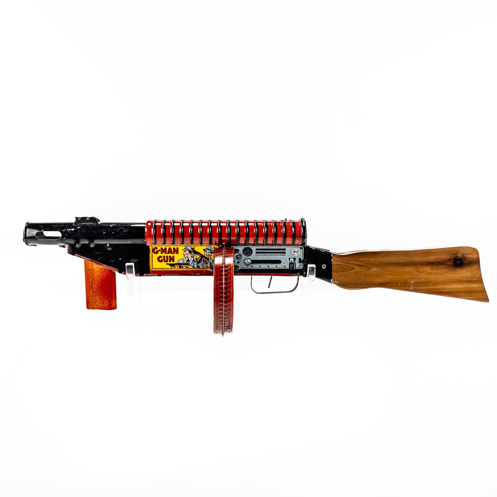 1940s MARX G-MAN Tin Litho Toy Tommy Gun: 1940s MARX G MAN 24" long tin litho toy Tommy Gun. Good overall condition with some age and wear imperfections present including some dings, discoloration, scuffs & scratches (with restored wood stock