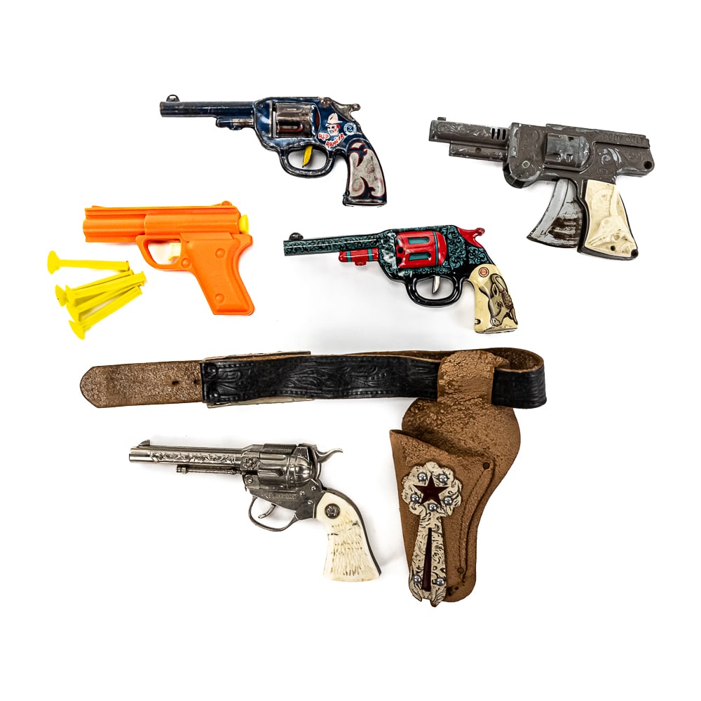 Collection of Assorted Vintage Toy Pistols: Collection showcases Wyandotte Rancher with holster, Lasso Em In Bill, Cody Colt, Spitfire die cast toy revolvers, vintage orange plastic dart gun with darts, and Ohio Art & Wyandotte tin litho toy pi