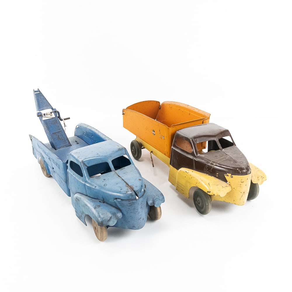 Buddy L Gravel Dump & Wrecker Pressed Steel Trucks: Collection showcases Buddy L tri colored pressed steel toy sand and gravel dump (shark nose) truck and blue Buddy L wrecker transport truck Both are approximately 18" long and in good overall conditio