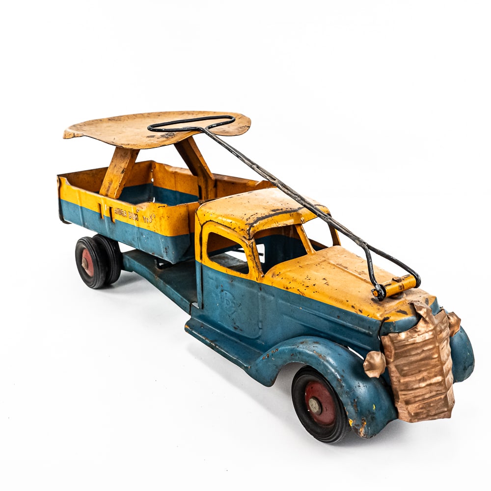 1930s Buddy L Pressed Steel Rider Dump Pull Truck: 1930s Buddy L Rider dump truck ride on pull toy. Approximately 24" long and in good to fair overall condition with cosmetic imperfections such as minor dings & dents, chips/scuffs/ discoloration/ pain