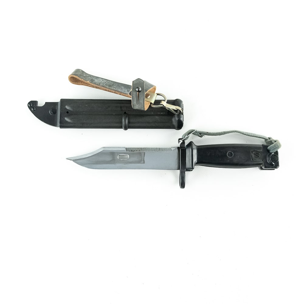East German AKM Type II Bayonet: East German surplus Type II bayonet for AKM Rifle. Black plastic handle and sheath model. Bayonet is in excellent surplus condition with minor blade wear from scabbard. scabbard and handle have matchi