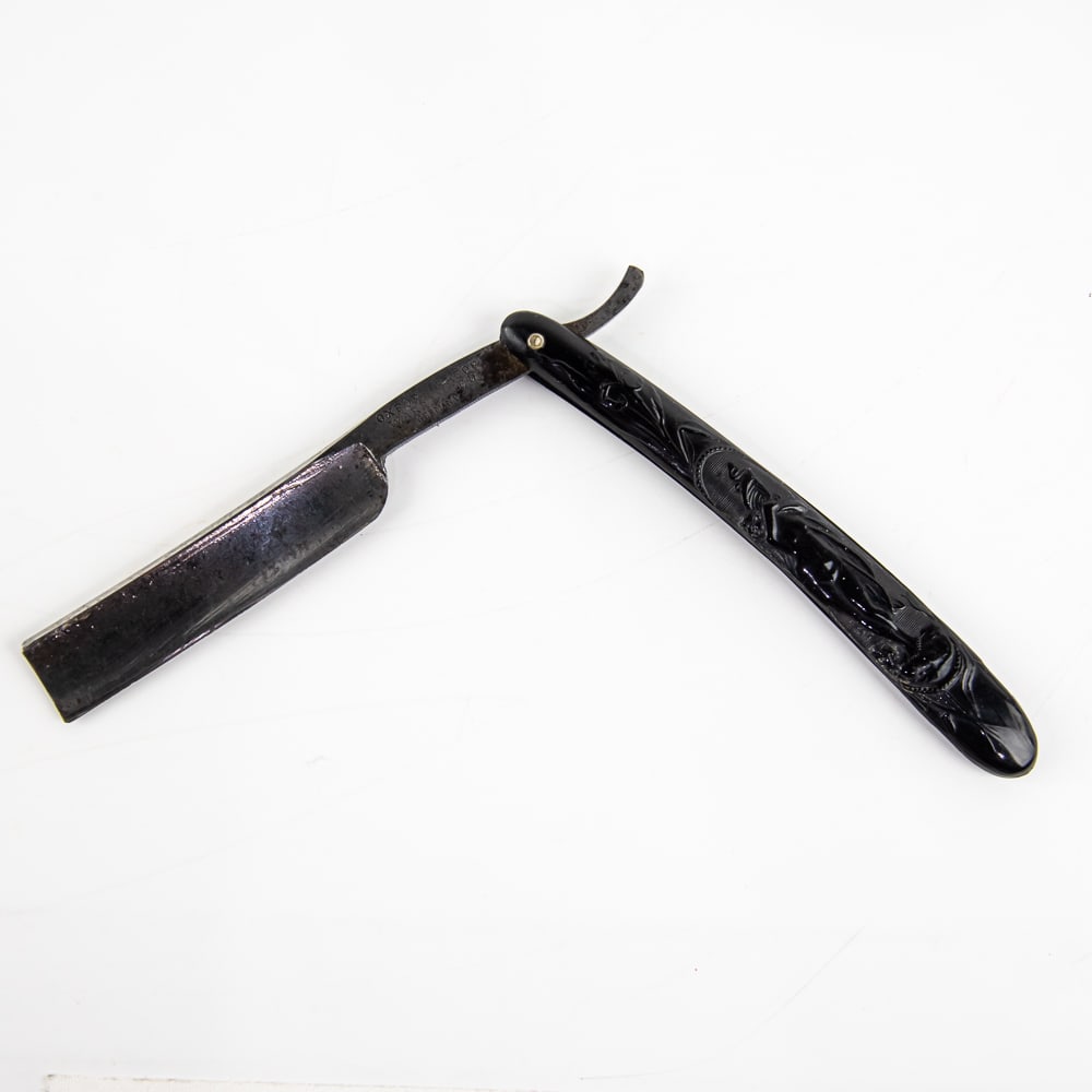 Oxford Razor Warranted Nude Straight Razor: Vintage Straight Razor by Oxford Razor. Has black celluloid scales with embossed nude woman, with a blank face. Tang reads "Simmons Hardware Co Germany" and reverse is blank. Has a square point blade,