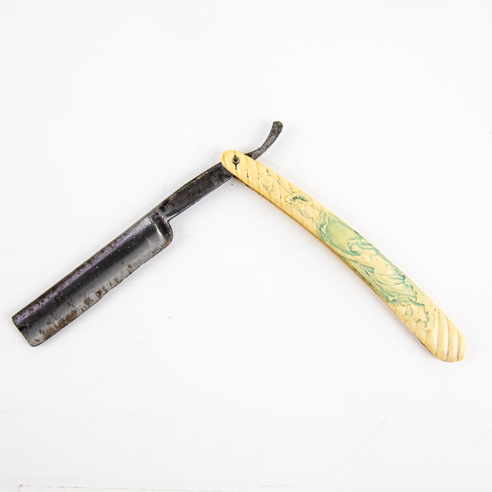 The Star Co. Nude Straight Razor: Vintage Straight Razor by The Star Co. Has off-white barber-style-swirl celluloid scales with nude lady embossed on front, with blue coloring within, and has a blank face. Tang reads "The Star Co. Sol