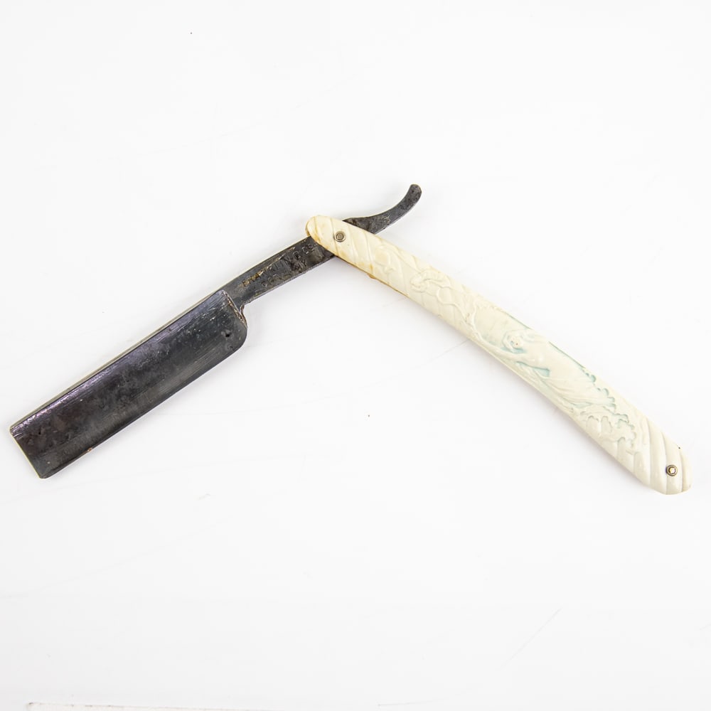 Franklin C. Co Nude Straight Razor: Vintage Straight Razor by Franklin C. Co Germany. Has white barber-style-swirls celluloid scales with nude lady embossed on front, with faint light-blue coloring within, and has a blank face. Tang rea