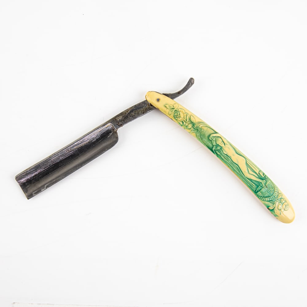 Simon Pure Cutlery Co 052 Nude Straight Razor: Vintage Straight Razor "052" by Simon Pure Cutlery Co. Has off-white/yellowed celluloid scales with nude lady embossed on front, with heavy blue coloring within, and has a blank face. Tang reads "Simo