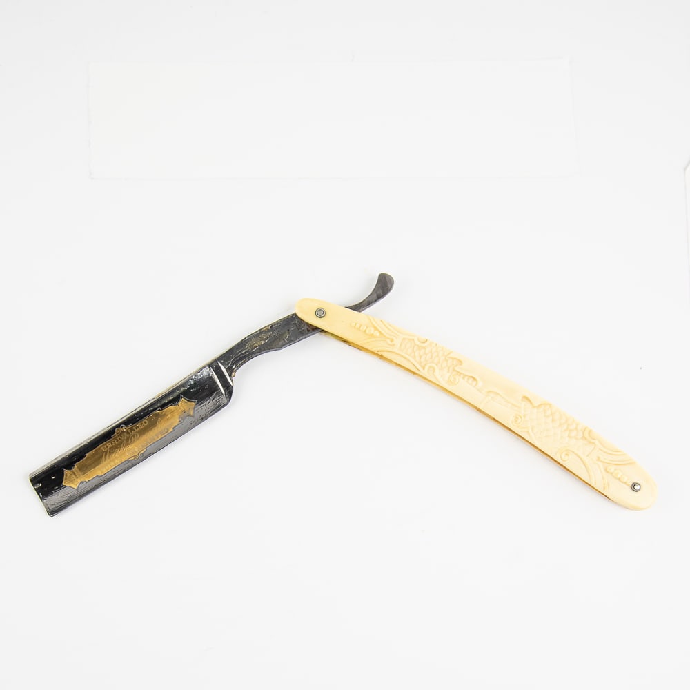 Levering Razor Co Mail Pouch Straight Razor: Vintage Straight Razor "Mail Pouch" by Levering Razor Co. Has off-white/yellowed scroll-themed celluloid scales with textures and various designs present, and a face with golden print of "Unrivaled Ma