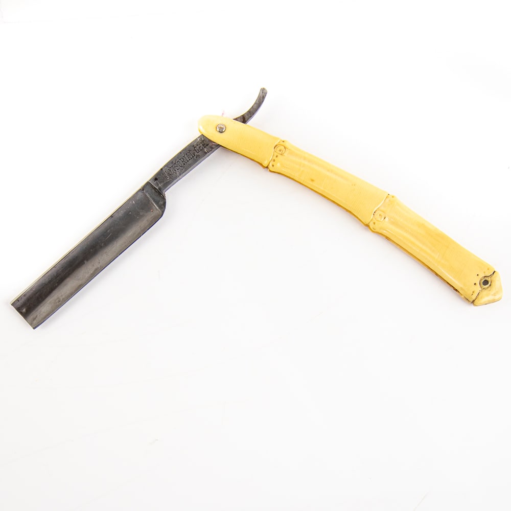"Tonsorial Gem" Straight Razor: Vintage Straight Razor, "Tonsorial Gem". Has cream bamboo-style bakelite scales, with a blank face. Tang reads "Tonsorial Gem" and reverse reads "M.I. Germany For H. Schweitzer Altoona Pa." Has a squa