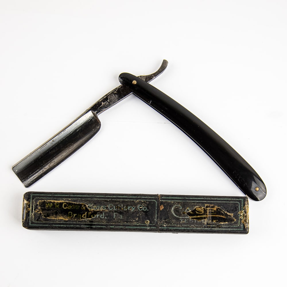 B & L Straight Razor w/ Unorig. Box: Vintage Straight Razor by B & L. Has black Bakelite scales, with "Baker" unprofessionally engraved/scratched into scale near wedge pin. The face is blank, Tang reads "B & L" encircled, and reverse is 