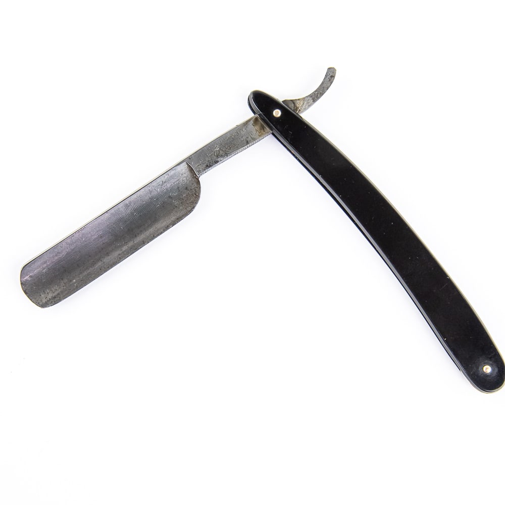 Geneva Cutlery Corp. Straight Razor: Vintage Straight Razor by Geneva Cutlery Co. Has black plastic scales. The face is blank, Tang reads "Geneva Cutlery Corp. Geneva N.Y. U.S.A", and reverse is blank. Has a round point blade, which is i