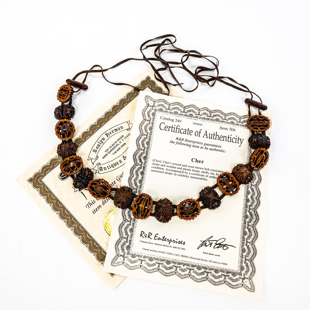 CHER Owned/Worn Leather Belt w COA: Collection showcases singer songwriter superstar Cher owned and worn brown leather belt with R&R Enterprises & Roslyn Herman COAs. "A Series of Walnut shells? Sewn together with leather to form a belt