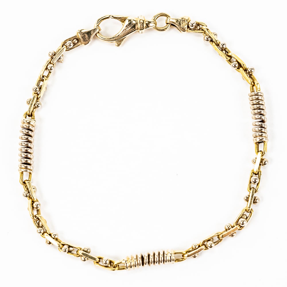 Ladies 7" 14K White on Yellow Gold Bracelet: Striking Ladies 7" 14k gold ornately detailed bracelet featuring white gold accents on yellow gold setting showcasing visually attractive highlights. Gold setting really helps the white gold accents "