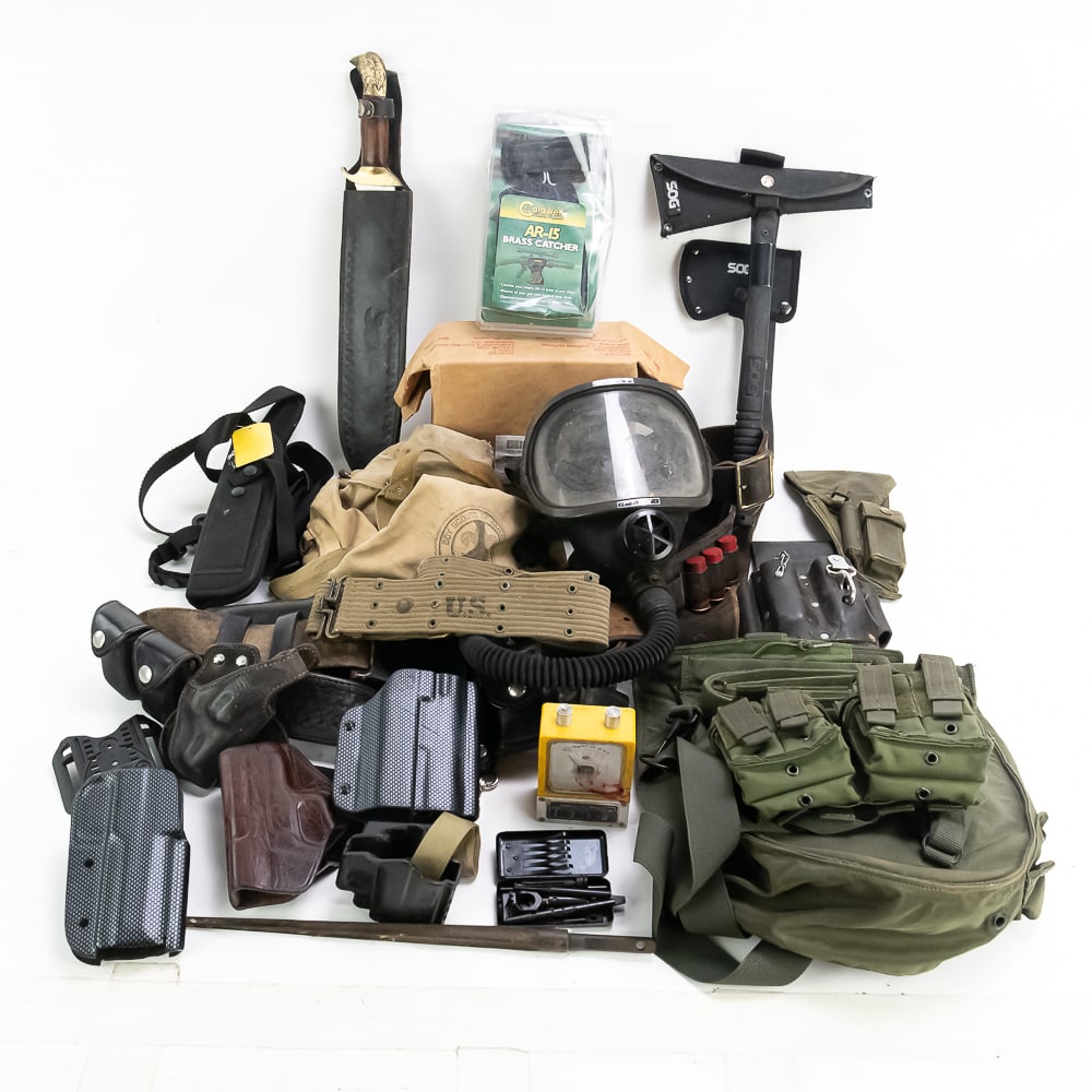 Assorted Surplus, Knife, and Gun Lot: Large lot of military surplus, Knives, and gun items. Holsters, gas mask, large bowie knife, SOG Tomahawks, Military Radio Headset, and mixed holsters, gun belts and gun items. Condition ranges from b