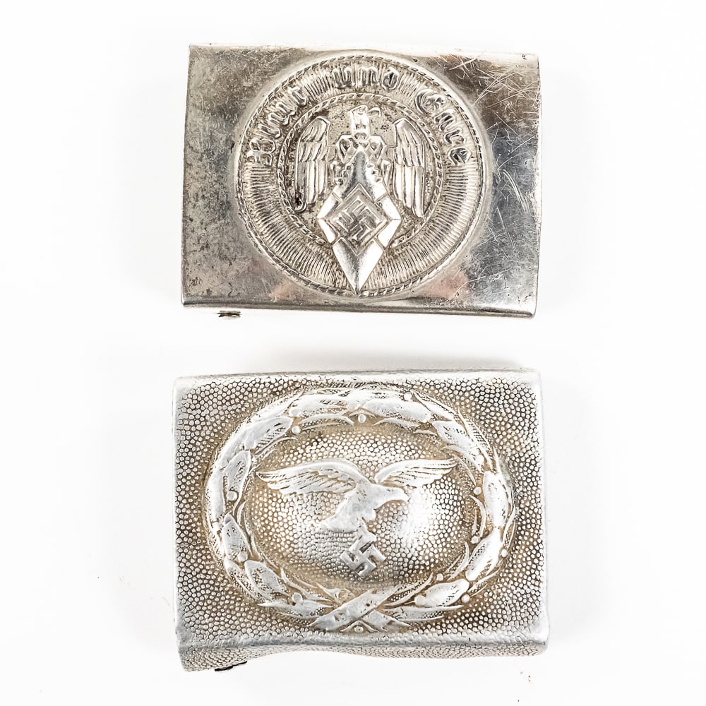WWII German Belt Buckles: Luftwaffe & Hitler Youth: 1) WWII Luftwaffe aluminum belt buckle exhibits some wear, specifically on wreath and eagle body, but retains detail on the wings and wreath edges. Buckle is misshapen, but should be able to be straig