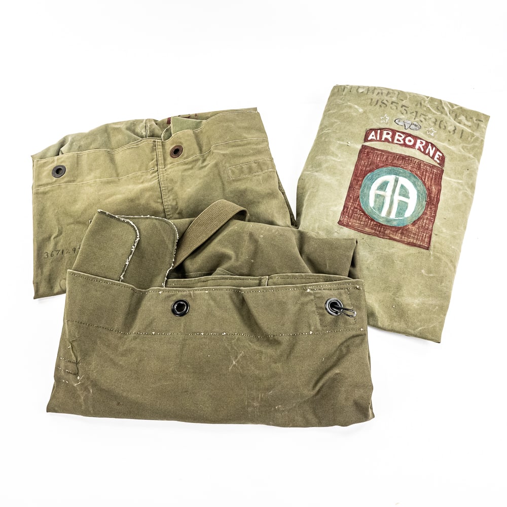 WWII, Cold War Duffel Bags-1st ID, 82nd ABN: A trio of US Army issued canvas duffel bags circa 1940's-1950's. The first is manufactured 1944, John Inglestroem Co. Stenciled in brick red paint "RE-2127-32" Above that is pen and ink black& red 1st