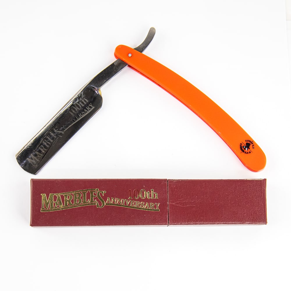 Marble's 100th Anniversary Razor w/ Orig. Box: Vintage Straight Razor by Marble, with orange plastic scales and logo near wedge pin. The face reads "Marble's 100th Anniversary", Tang and reverse are blank. Blade is in overall pristine condition, w