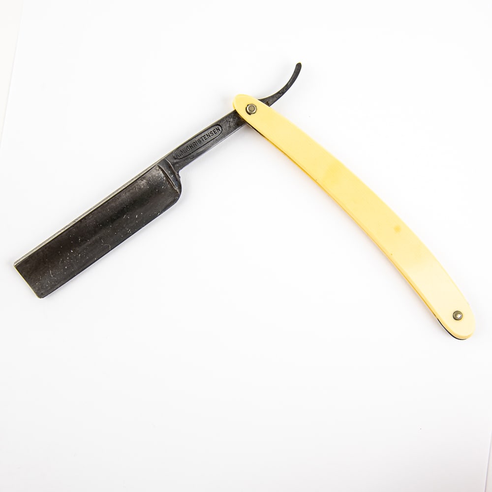 H. M. Christensen Straight Razor: Vintage Straight Razor by H. M. Christensen. Has off-white/yellowed celluloid scales. The face is blank, Tang reads "H. M. Christensen", and reverse reads "New Bedford Mass." and a whale engraved. Has