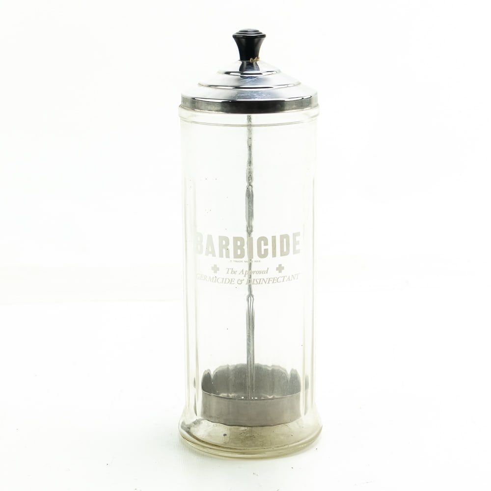 Vintage Barber Barbicide Jar: Vintage Barbicide Jar. Cyllinder made of Glass with no noticeable chips/cracks, in great condition. Front reads "Barbicide The Approved Germicide & Disinfectant." Measures approximately 4"D X 11.5"T. 