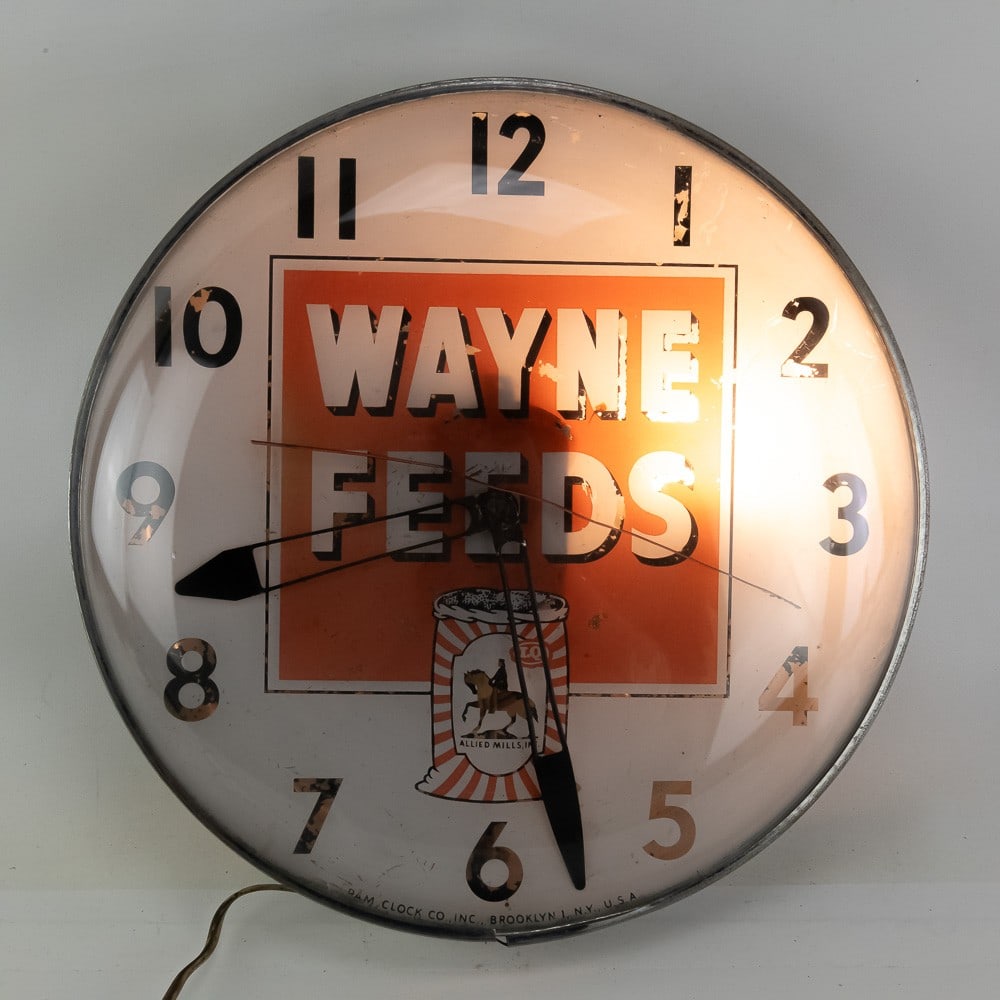 Wayne Feeds Advertisement Clock: This is a fantastic example of a mid-century electric advertising wall clock, a staple of general stores and farm supply shops in the 1940s and 1950s. This piece prominently features the branding for