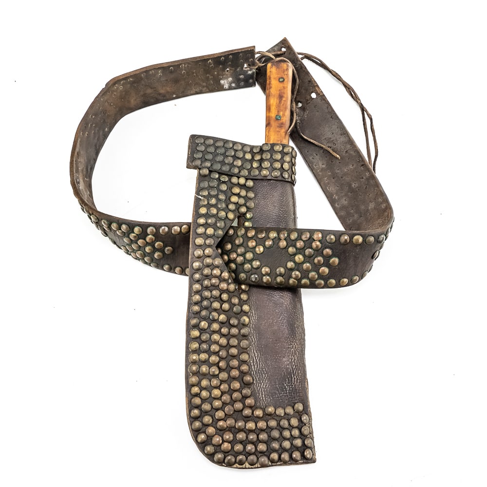 1880s Northern Plains Tacked Belt W/Knife & Sheath: This Northern Plains tacked belt and knife sheath circa 1880s is crafted from harness leather and adorned with rows of brass tacks on one side. Leather is supple and live. Knife w/ wooden grip marked