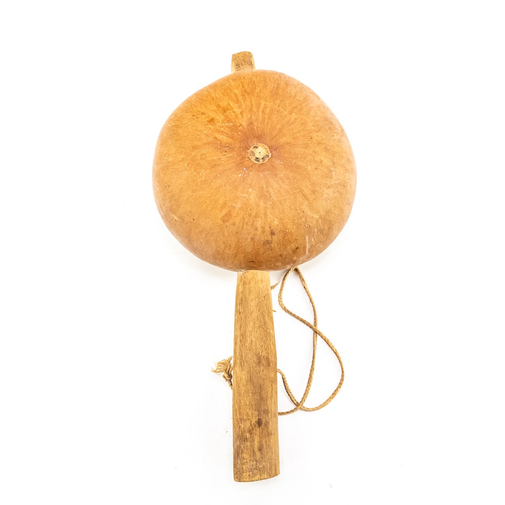 Hopi Gourd Rattle: This Hopi gourd rattle would have been used in ceremonies and dances. Constructed from a dried gourd with a wooden handle inserted through the center and secured with a wooden pin at top. Light brown 