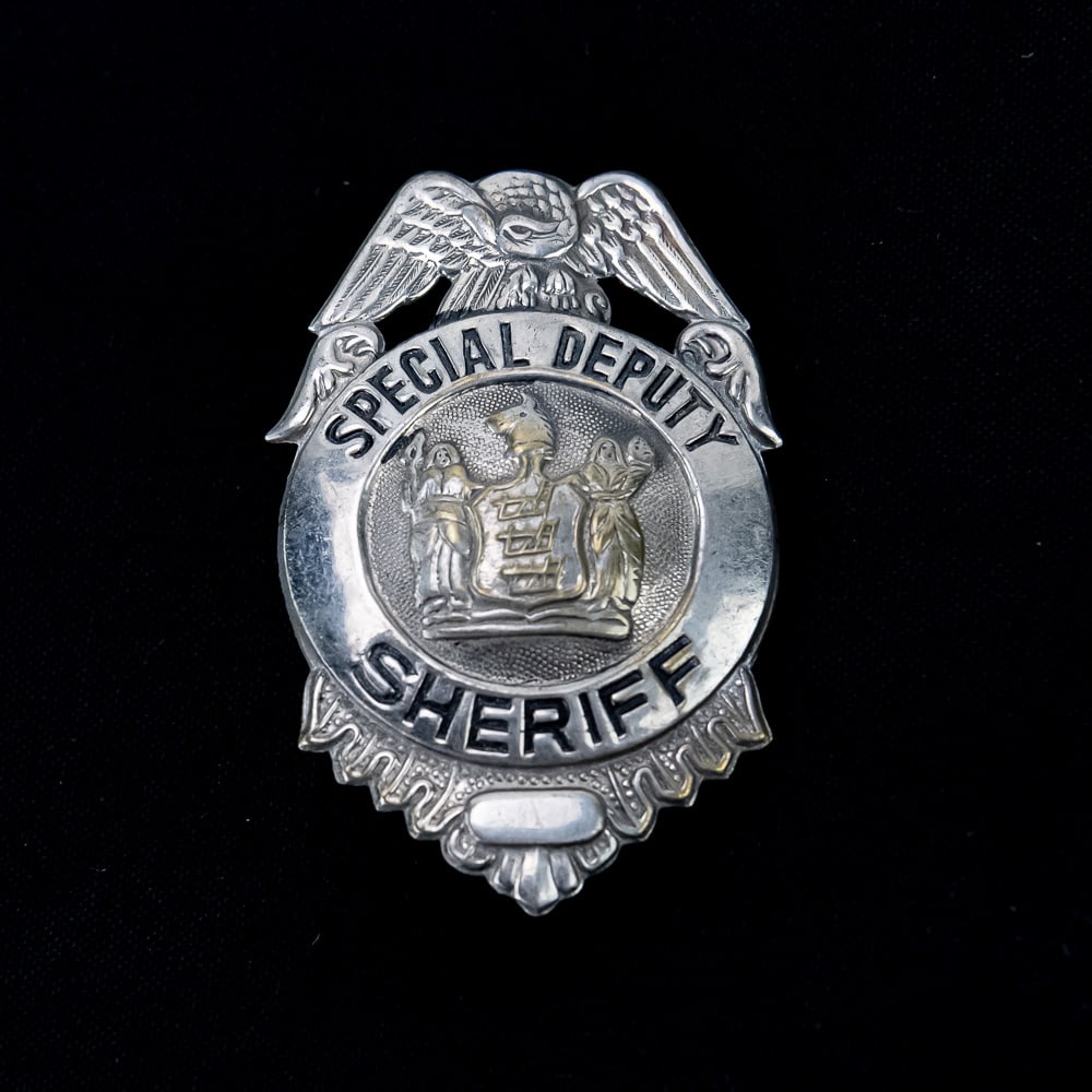 NY Special Deputy Sheriff Badge: This is a well-preserved example of a vintage "Special Deputy Sheriff" badge, likely dating from the mid-20th century, identifiable by the distinctive American bald eagle crest and the central Great S