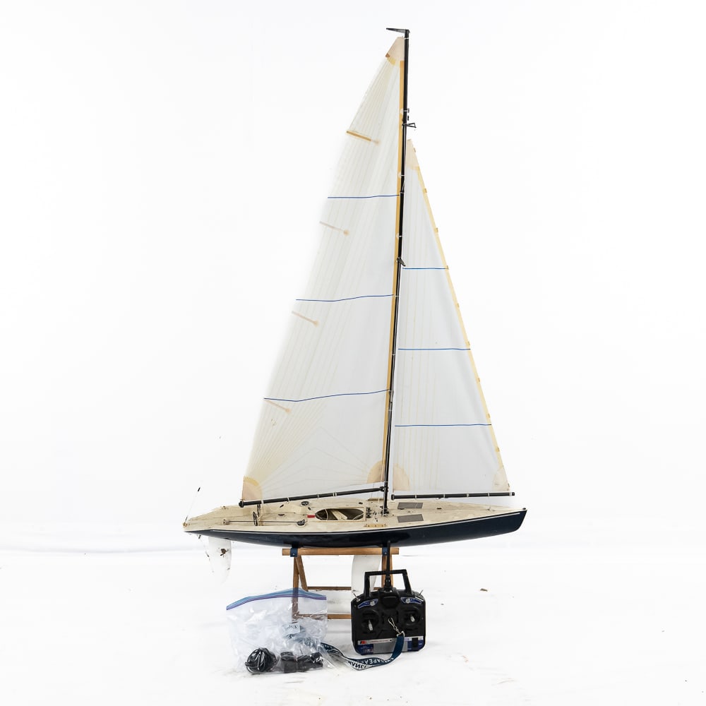 Radio Control 36" Model Sailboat & Transmitter: Electric RC racing sailboat. Unknown manufacture. Modern plastic construction. Hull measures 36” long x 8.5” wide x 61” from top of mast to base of keel. Rigging and sails look complete and func