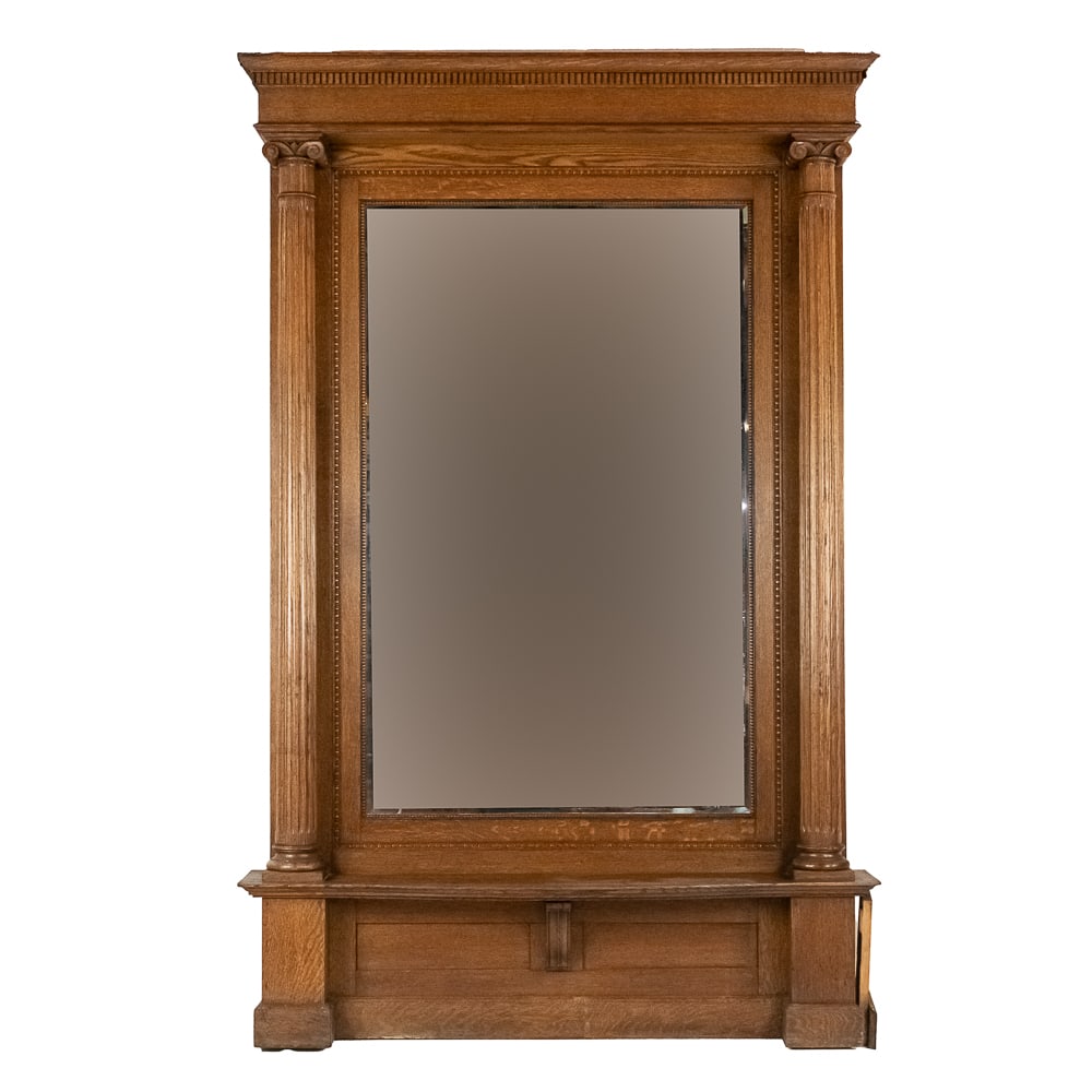 Large Oak Pier Mirror: Large oak pier mirror usually found in entry halls of large homes. Beautifully refinished oak with 2 fluted columns with capitol tops supporting a cornice with dentil trim. Mirror is beveled and in VG